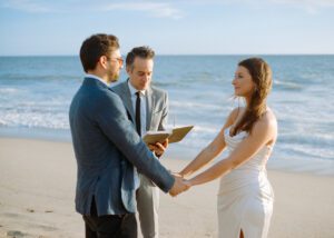 Romantic, dreamy couple eloping on Zuma Beach in Malibu by ordained officiant, taken on 35mm film